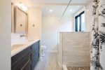 Full bathroom with stand up shower and tub on the lower level